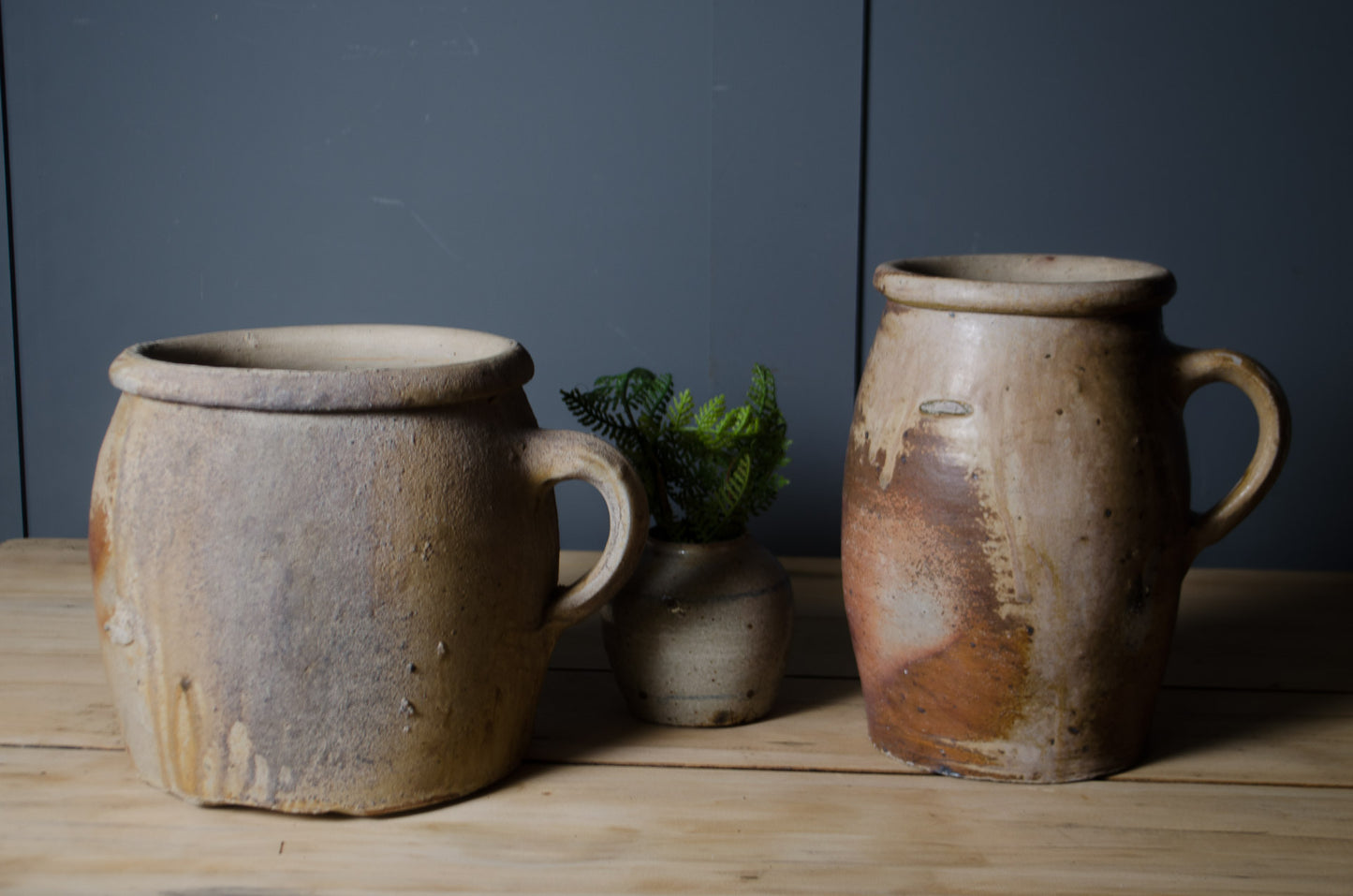 Pair of antique French confit pots with rustic stoneware glaze and original handles.