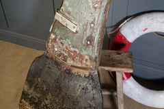 Close-up of a worn-out boot with a life preserver in the background