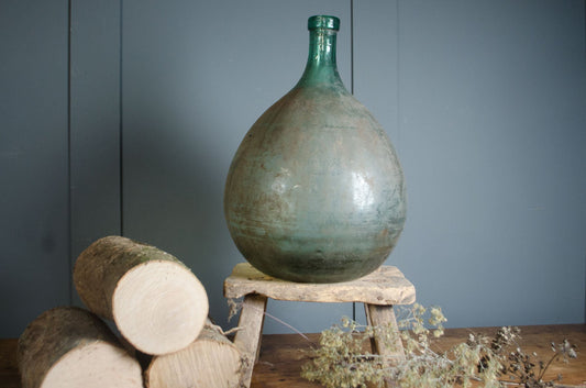 Small French glass demi john with aged surface
