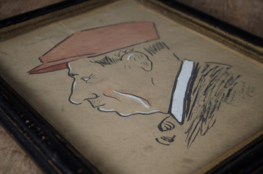 A framed portrait sketch of a man in profile wearing a reddish-brown hat, rendered in black and white line art on aged beige paper, shown in a dark wooden frame.