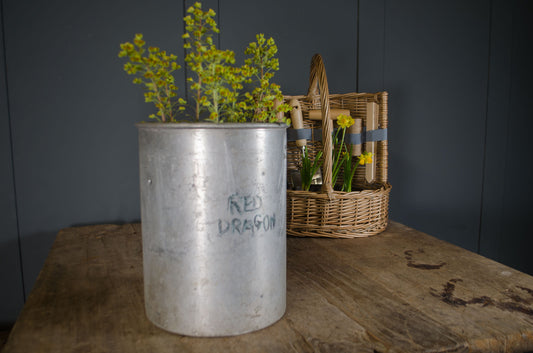 old firework canisters used as planters with herbs, showing aged metal finish and cylindrical form
