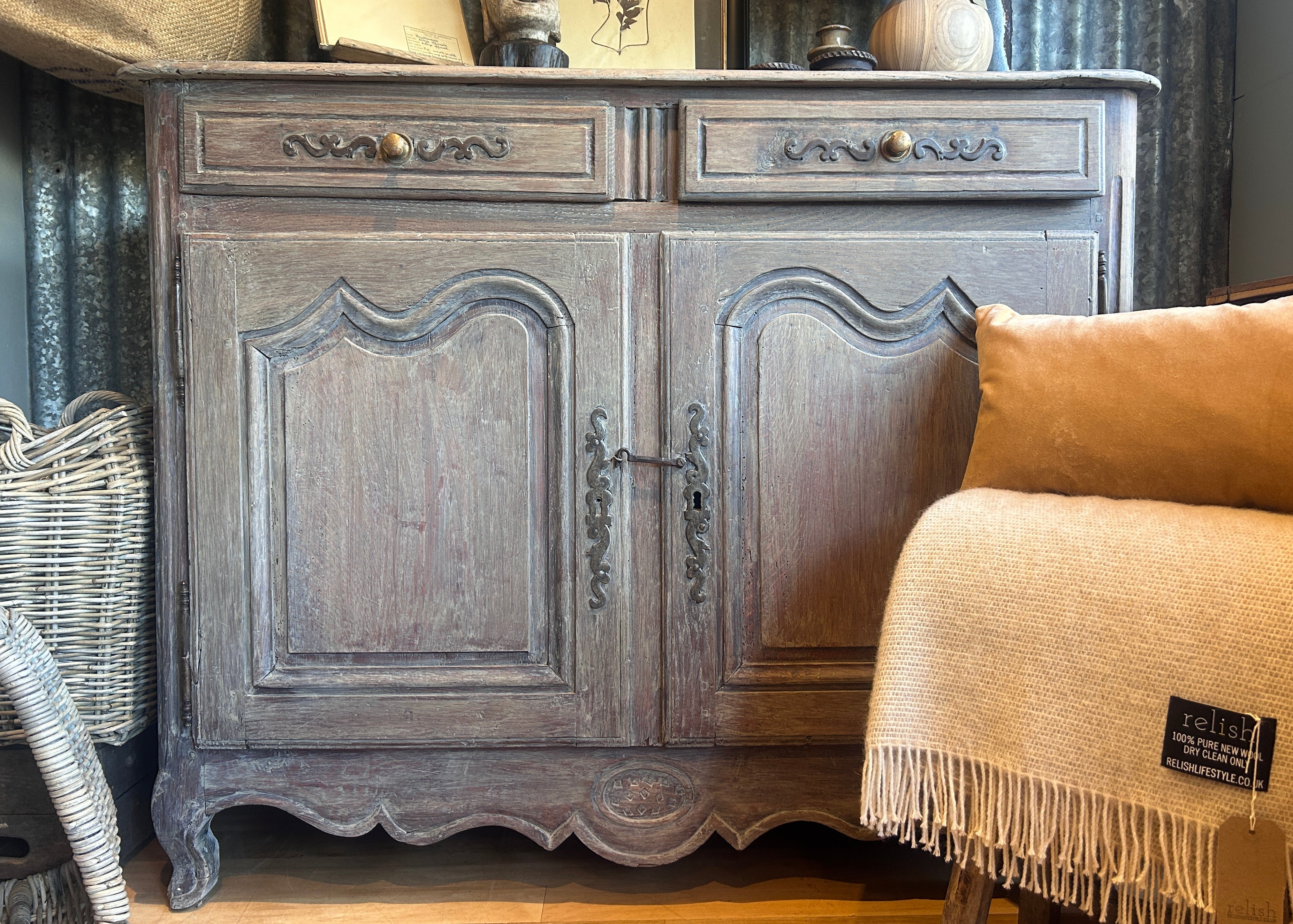 Antique French walnut sideboard featuring a lime washed finish, carved panel doors, and original brass fittings.
