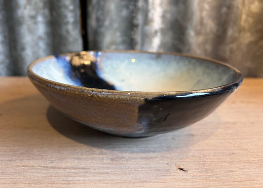 Ceramic bowl with a glossy finish on a wooden surface