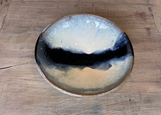 blue and white studio pottery bowl on bleached oak table