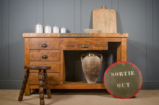 Antique French blacksmith bench with drawers used as a rustic kitchen workstation