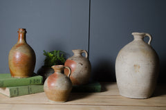 Antique French stoneware vinegar jar with handle and warm cream and terracotta glaze.
