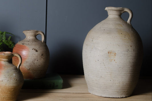 Large antique French stoneware vinegar jar with white glazed finish and rustic character.