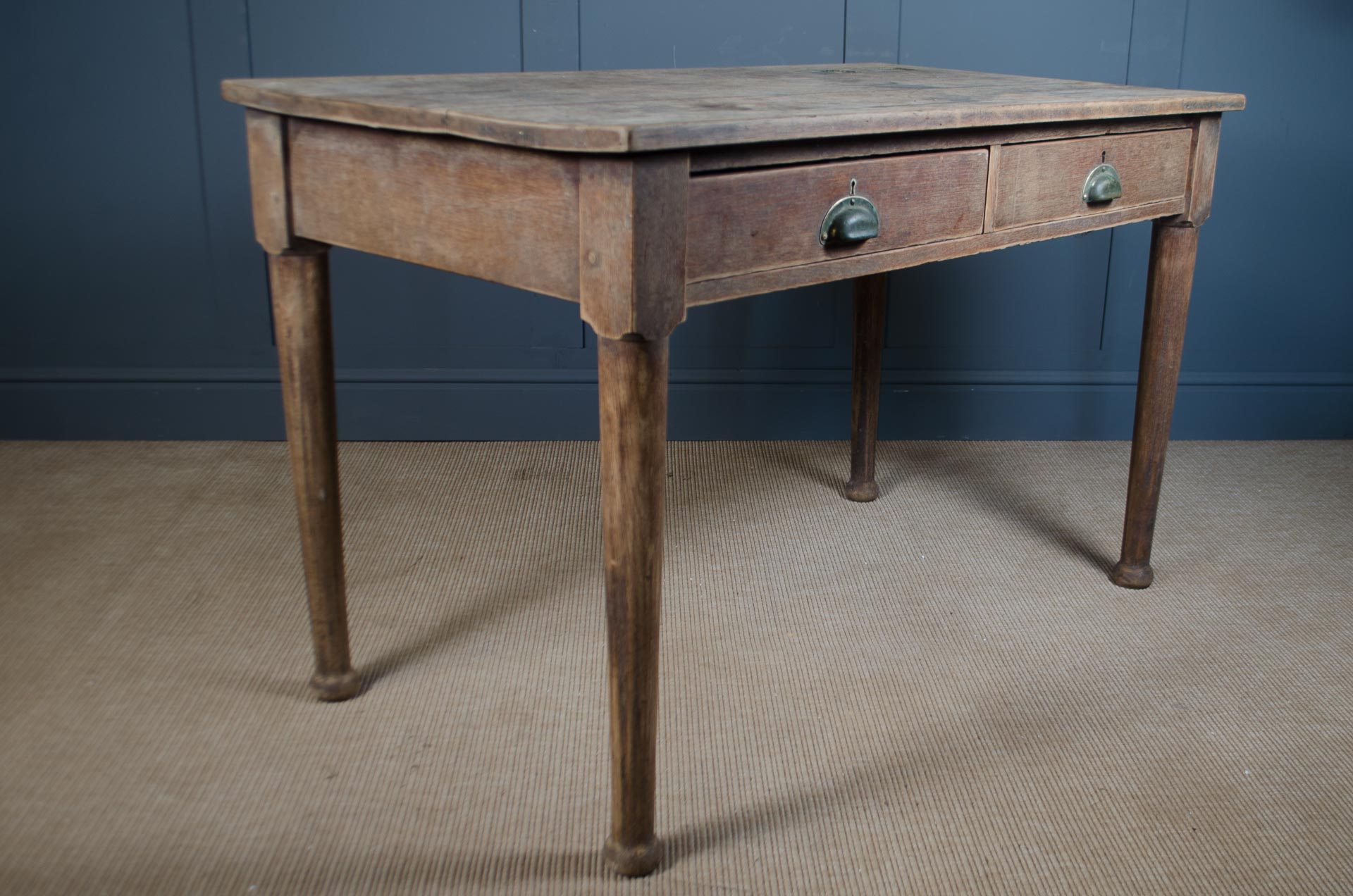 
Weathered oak writing desk with two drawers and aged wood top
