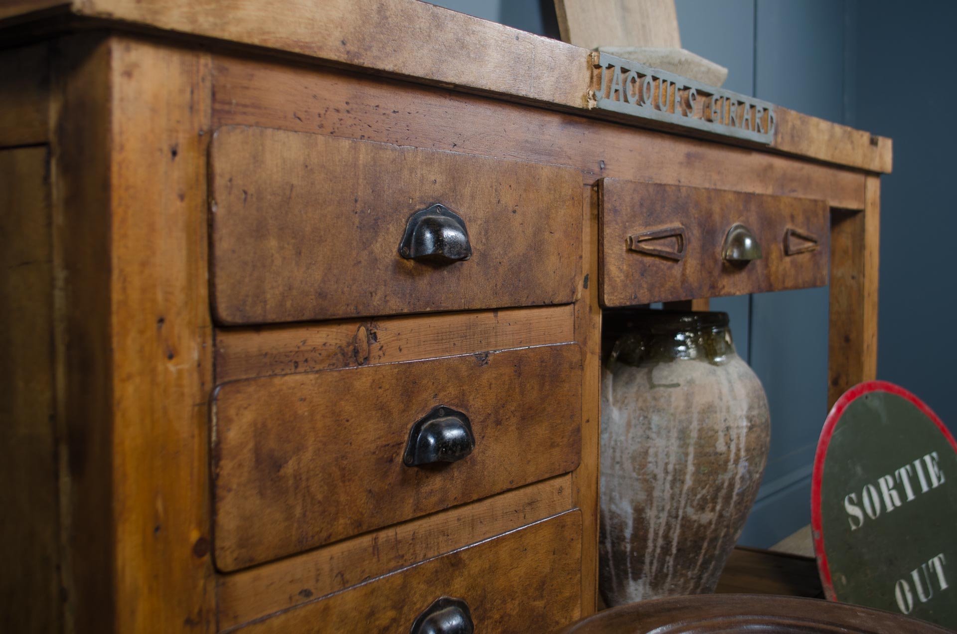 Rustic French blacksmith bench with open storage space and original wood top

