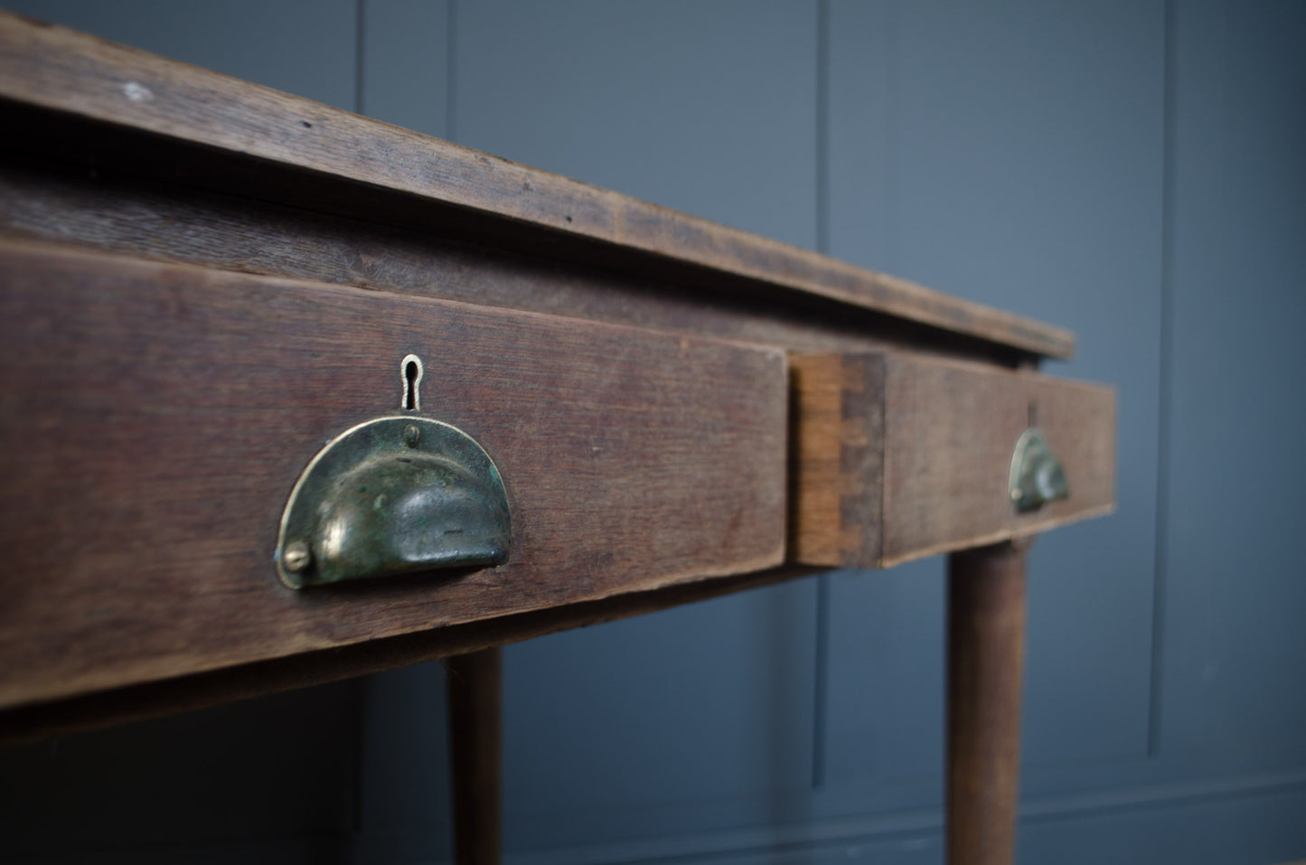 Detailed view of worn oak desktop surface with natural marks and patina
