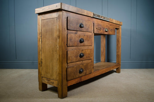 Solid wood French blacksmith bench with aged patina and original storage drawers