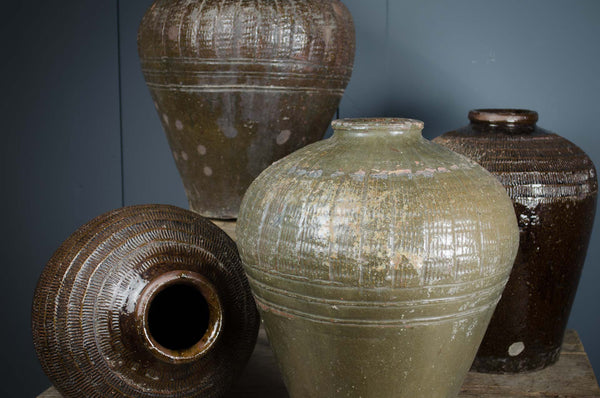 Fantastic rustic decorative pots in a tactile olive green or mid brown glaze. Originate from northern China where they were used to store prized rice wine. An unusual rare find, making them the perfect addition to any modern rustic interior decor. Add to a the corner of a room or sideboard with dried seed heads or autumnal branches for a unique focal point.&nbsp;The variations in colour and slight imperfections are signs of history and character behind each pot. Choose your favourite from the dropdown menu.