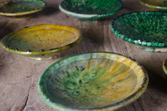 Green glazed Tamegroute pottery plates with rustic finish.