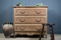 Stripped antique oak chest of drawers showing natural wood grain and patina