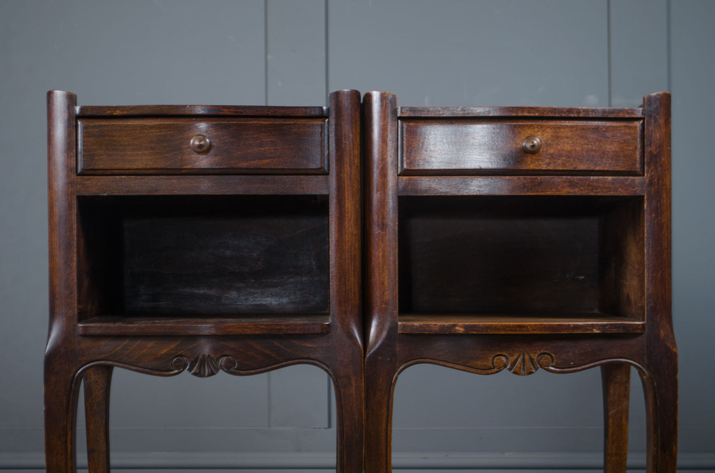 Vintage French nightstands in a dark wood finish with curved legs.