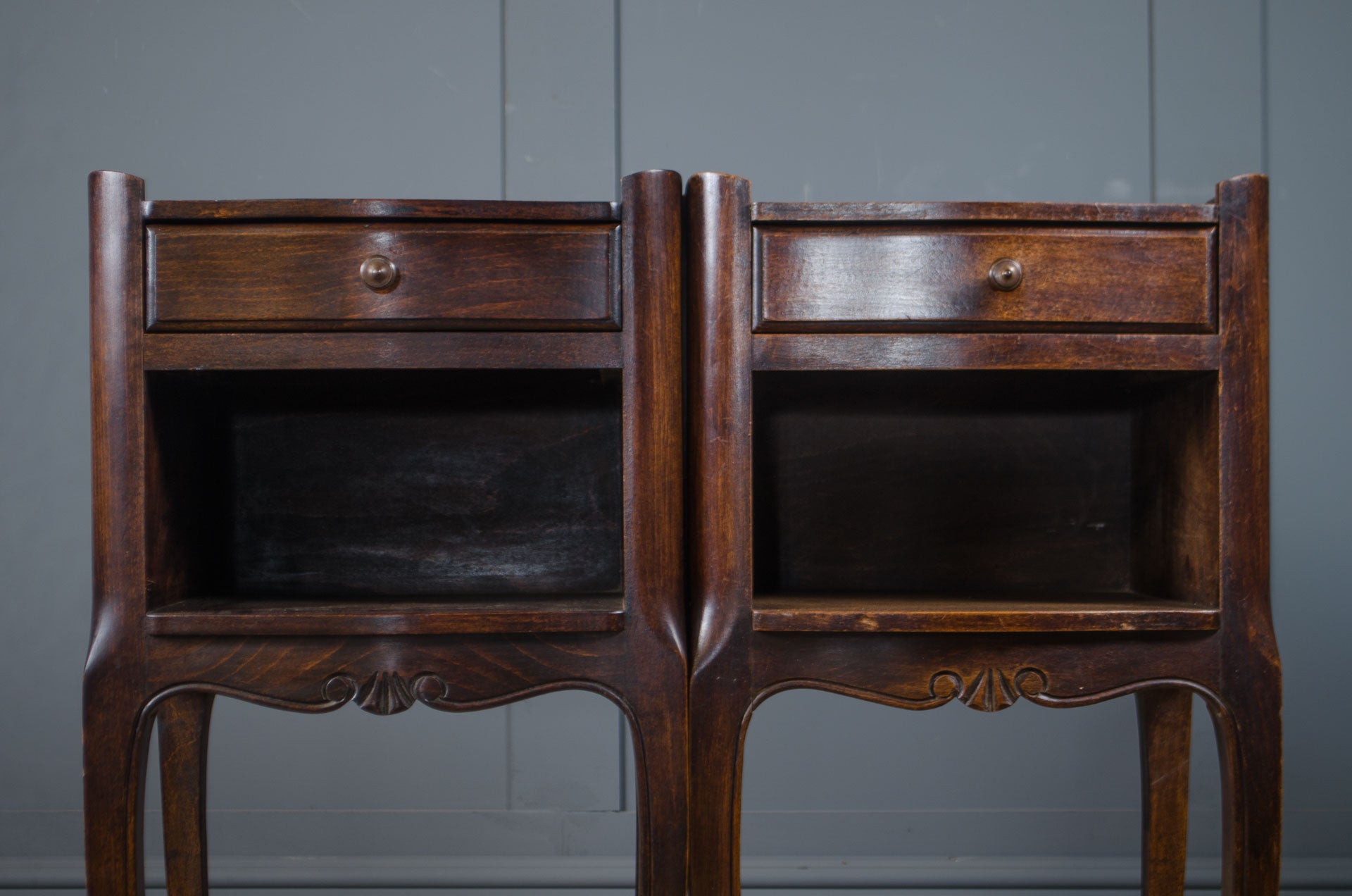 
Vintage French nightstands in a dark wood finish with curved legs.
