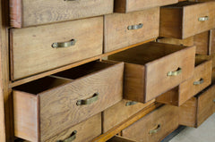 Wooden dresser with open drawers and visible brass hardware