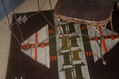 Two wooden chairs on a patterned rug with geometric design