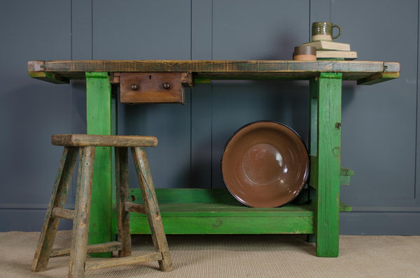 reclaimed Green wooden table workbench kitchen island with a brown plate and stool 