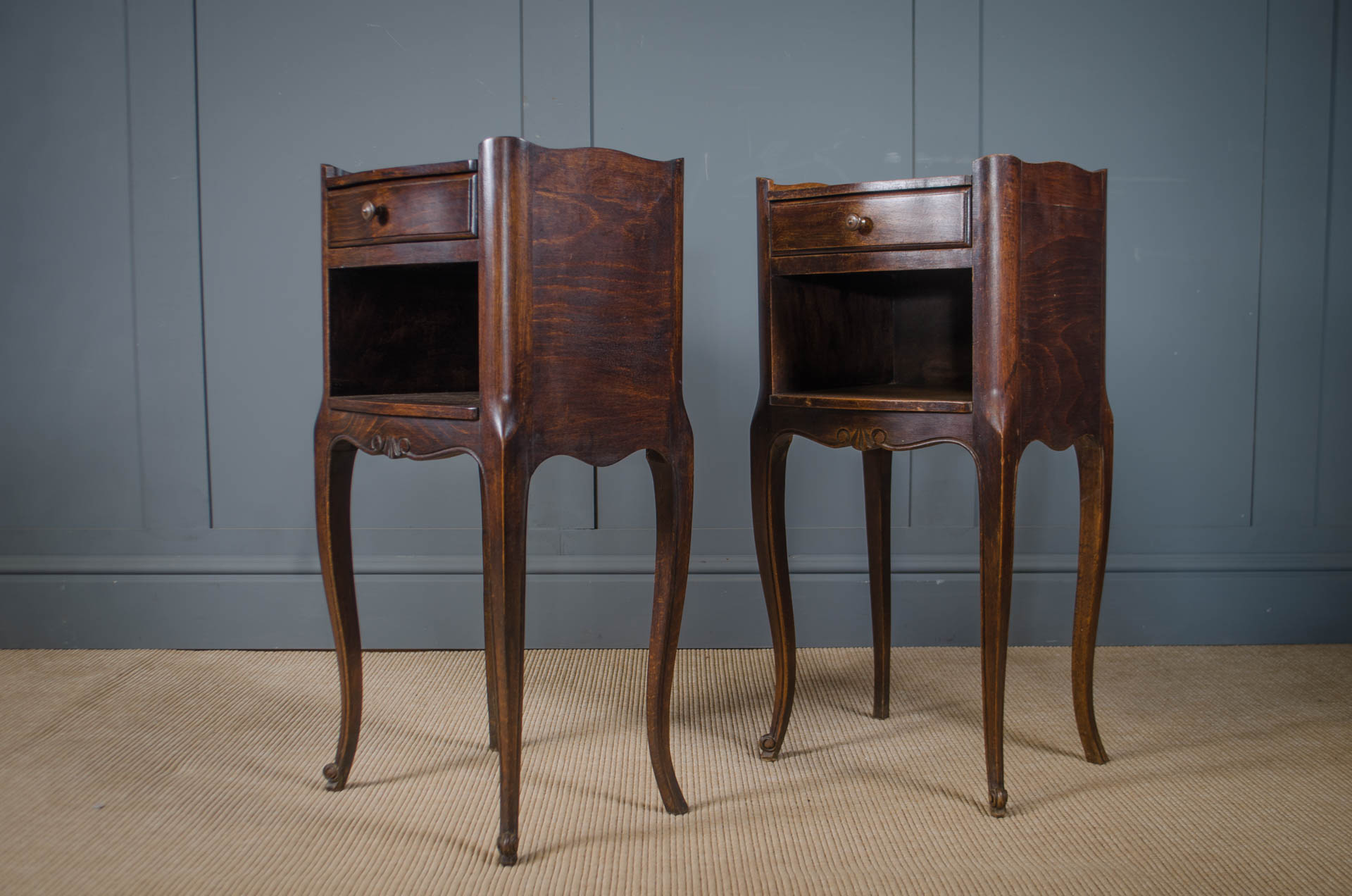 
Pair of French Louis XV style bedside tables with dark wood finish.