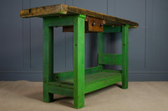 reclaimed Green wooden table workbench kitchen island with a brown plate and stool 