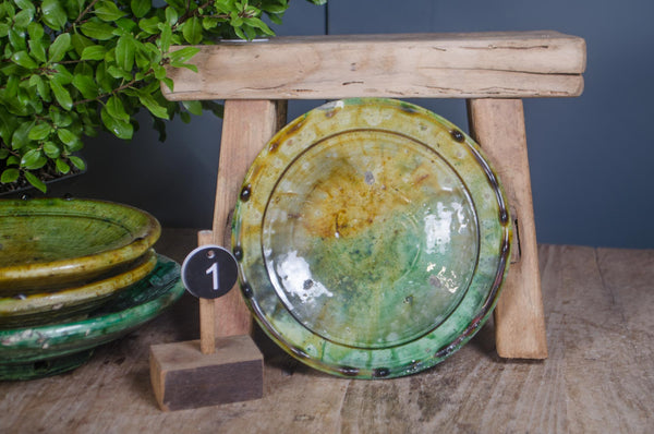 Tamegroute pottery dish stack showing olive and emerald glaze tones.