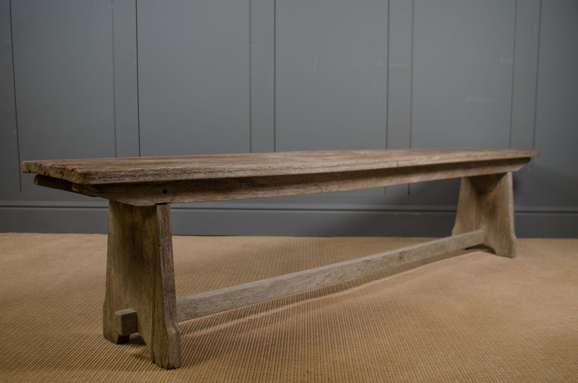 Antique oak bench with weathered grey finish and rustic wooden frame