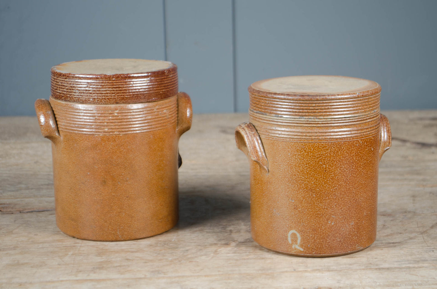 French salt glazed stoneware confit jar with original lid and side handles in a warm brown glaze.