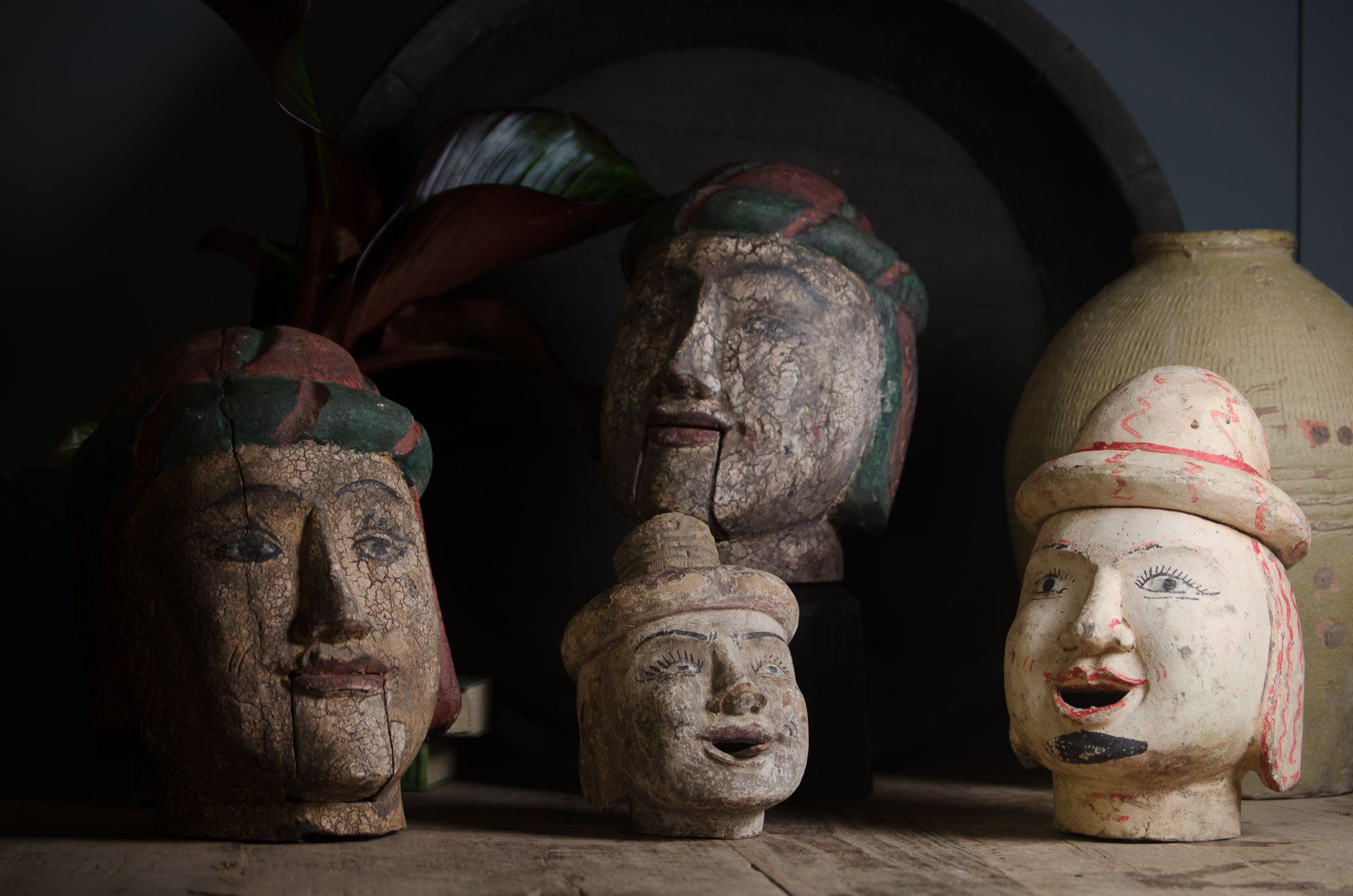 collection of hand painted antique Burmese puppet heads carved from wood