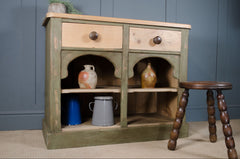 Victorian painted dresser in sage green with drawers and shelving.