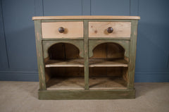 Olive green painted dresser base with decorative framing and storage drawers.
