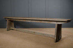 Rustic long oak bench styled in a hallway with vintage accessories