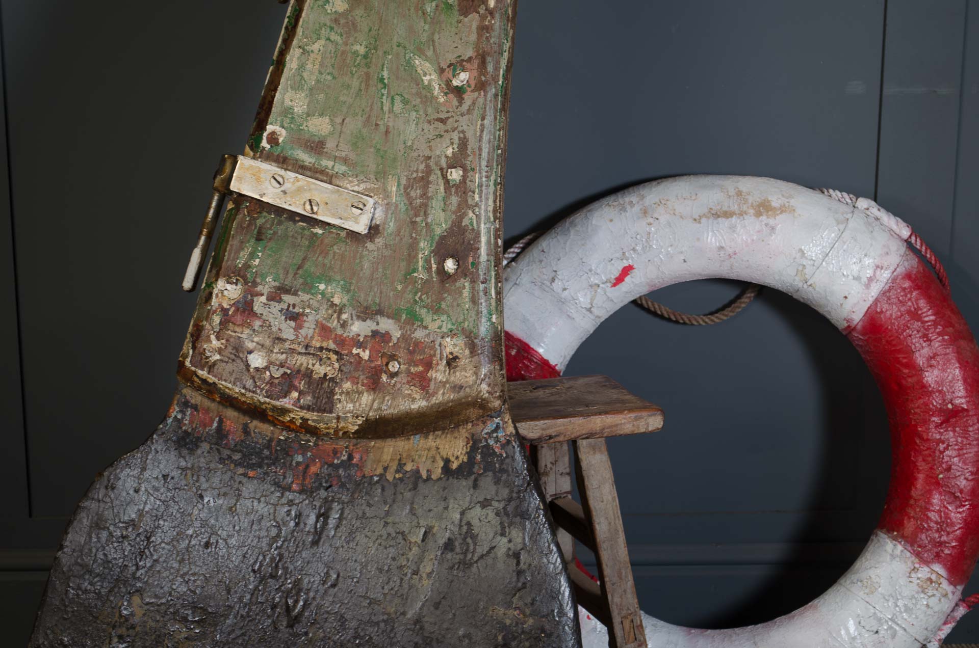
Vintage anchor with a life buoy against a dark background