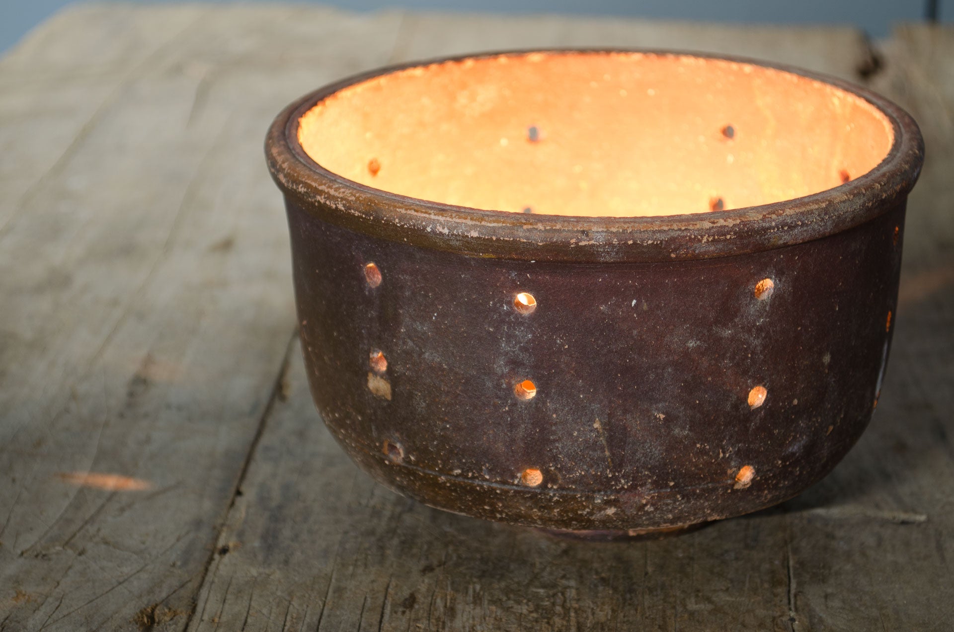 terracotta bowl with candles in it