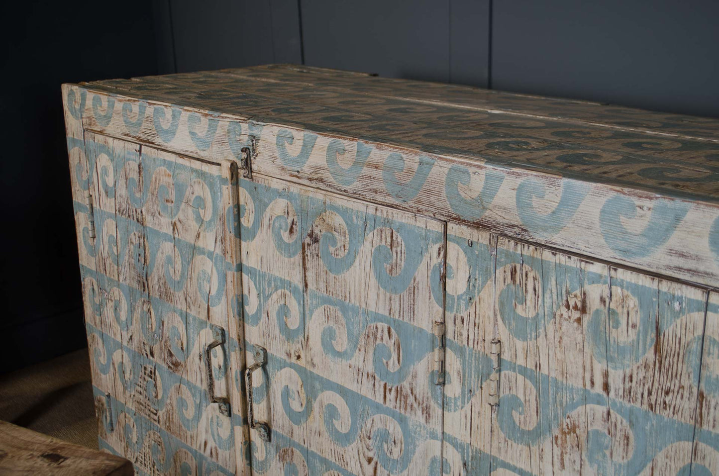 Wooden cabinet with decorative patterns on a dark background