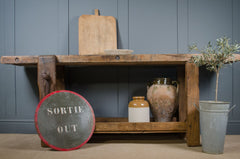 Rustic French workbench used as a kitchen island with lower shelf