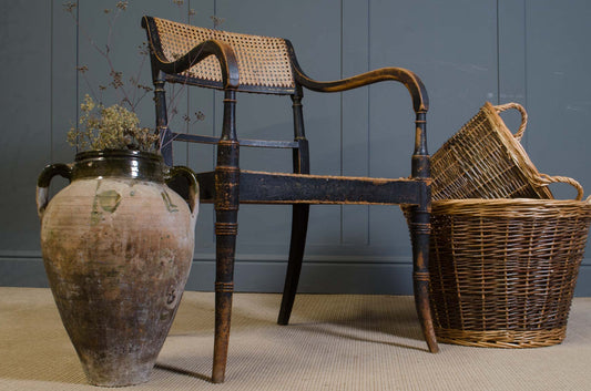 Country house Antique black wooden armchair with worn gilded detailing
