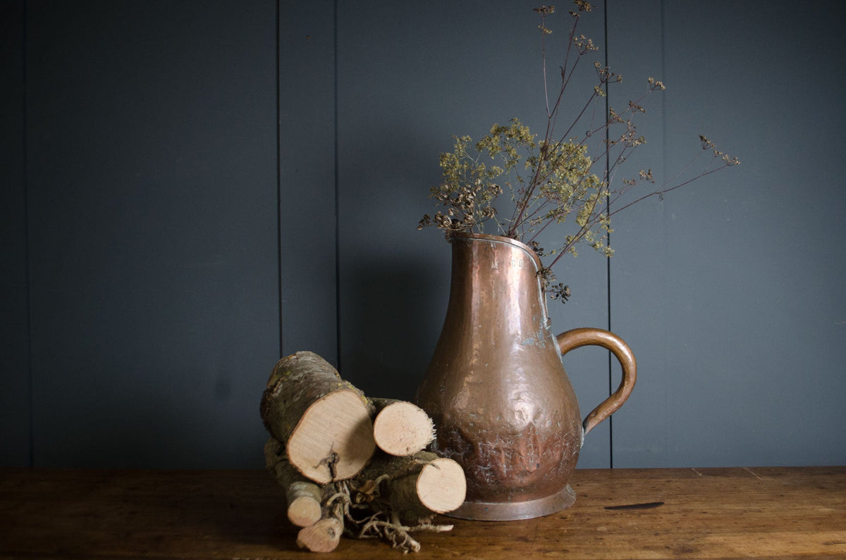 Antique French copper jug with patched hammered surface