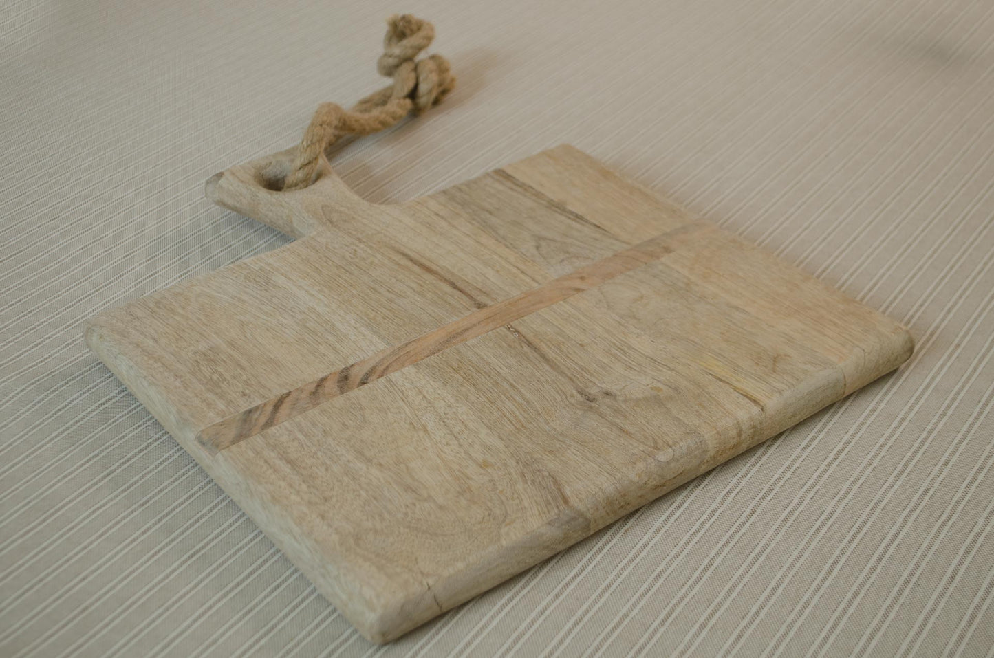 Reclaimed oak wood cheese board with olives, butter and sourdough bread
