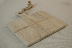 Reclaimed oak wood cheese board with olives, butter and sourdough bread