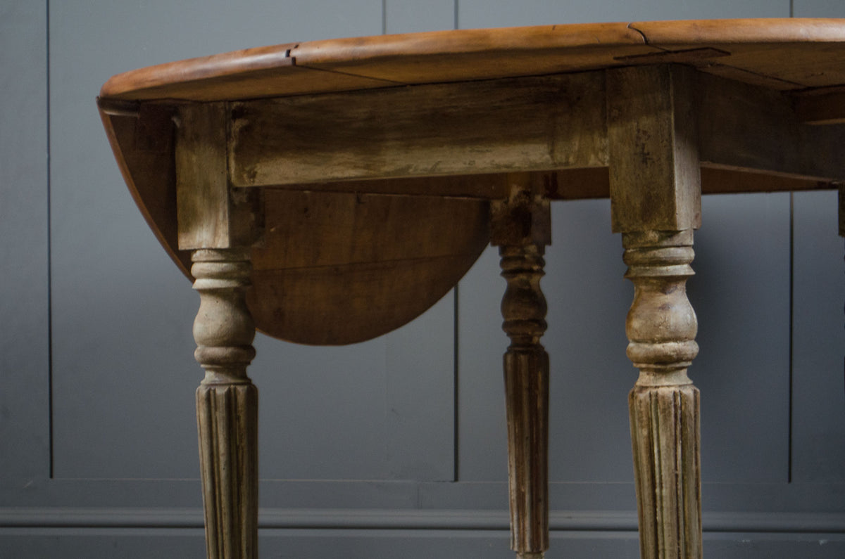 Round oak kitchen table with worn painted French base
