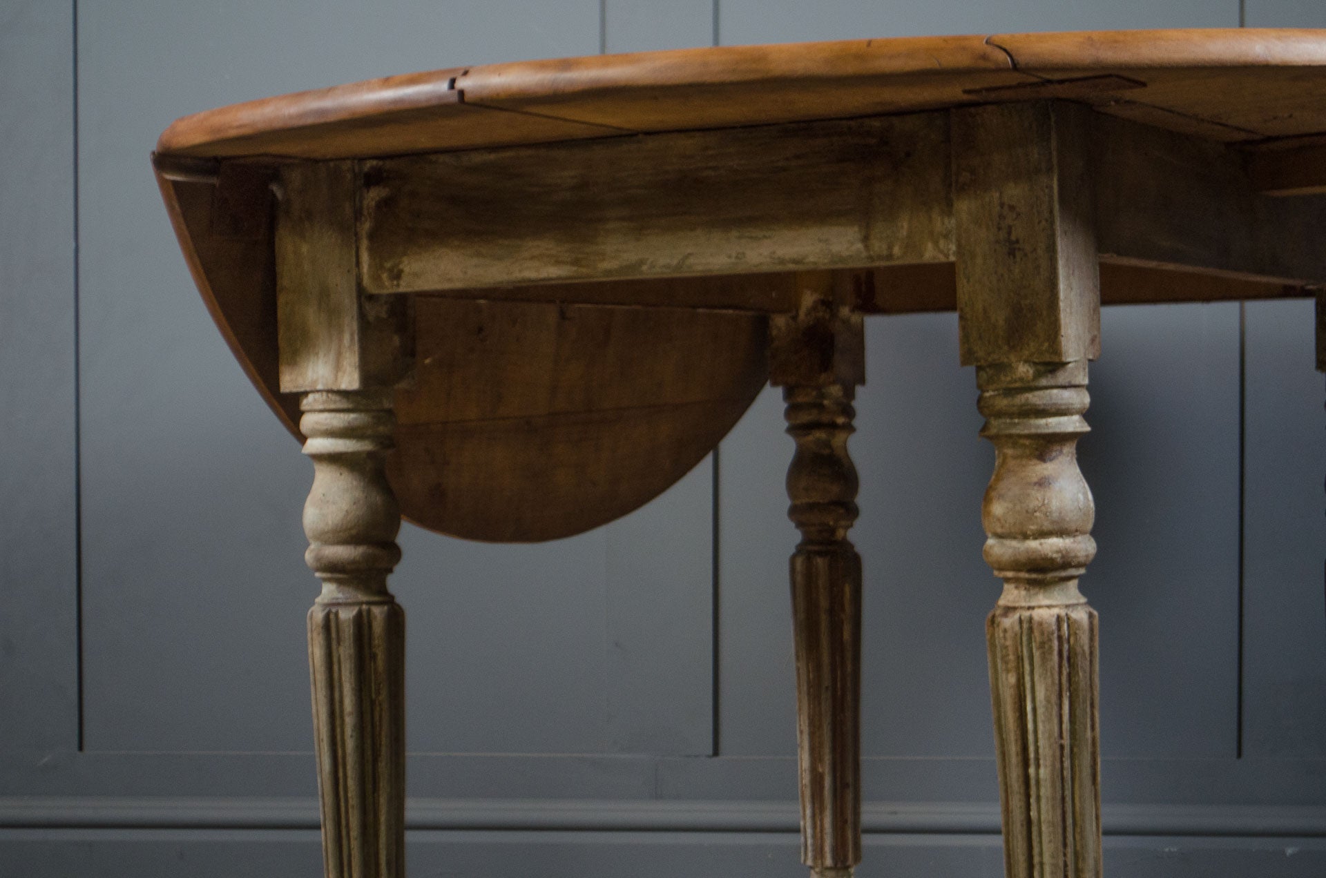 
Round oak kitchen table with worn painted French base