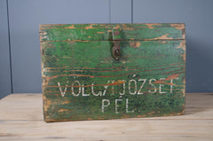 Antique painted travel box with weathered timber and hinged top.