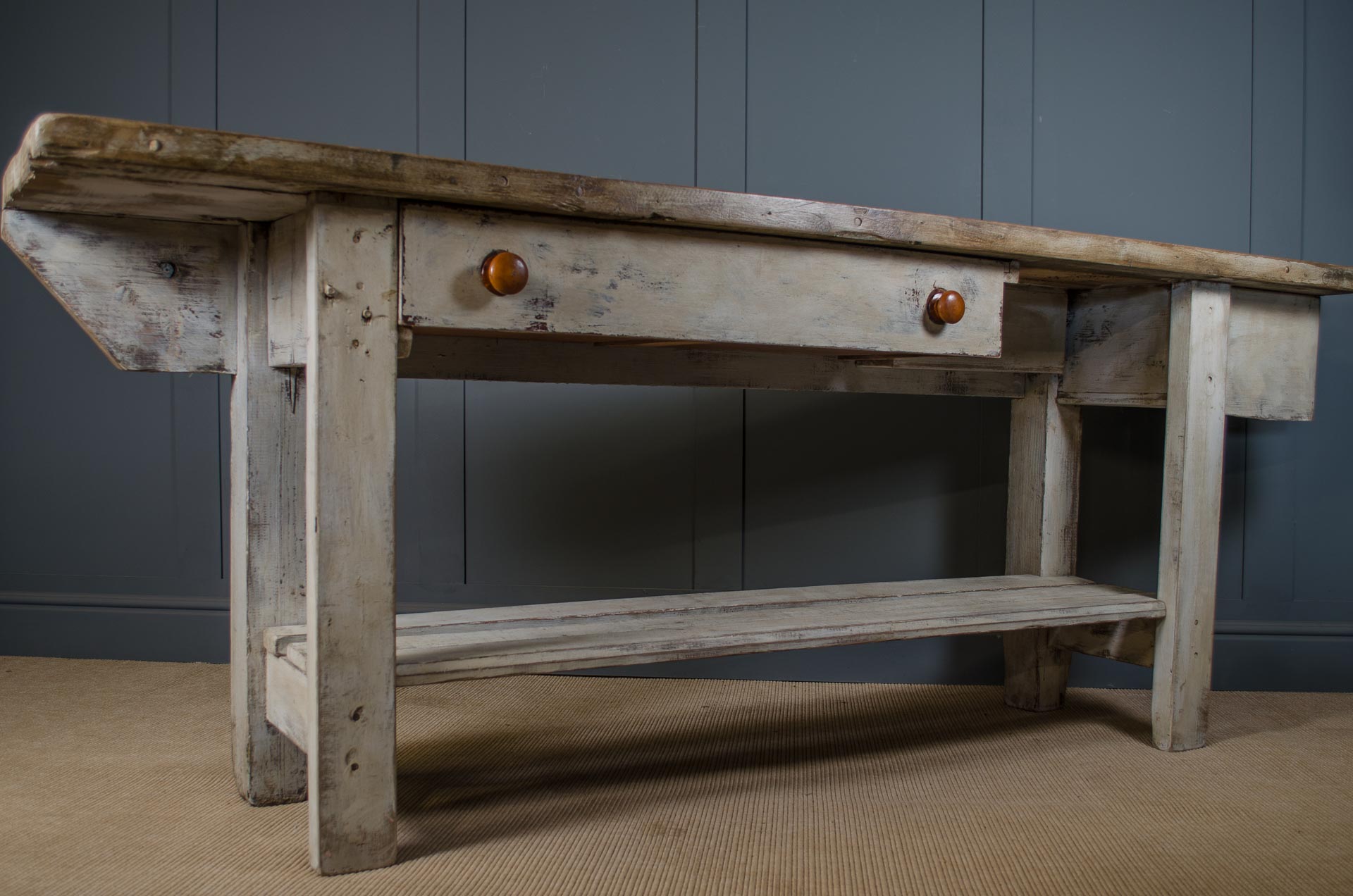 Wooden workbench with a rustic design against a gray wall. farmhouse kitchen island