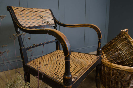 Victorian ebonised wooden carver chair with cane seat and back