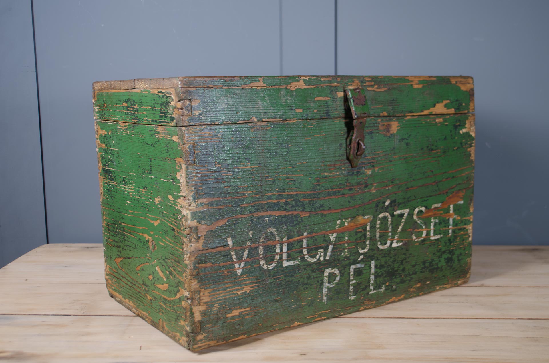 Rustic green painted storage trunk with hand-painted lettering.