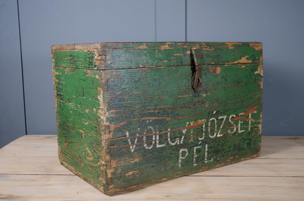 Rustic green painted storage trunk with hand-painted lettering.