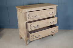 Stripped pale oak French chest of drawers with carved detailing