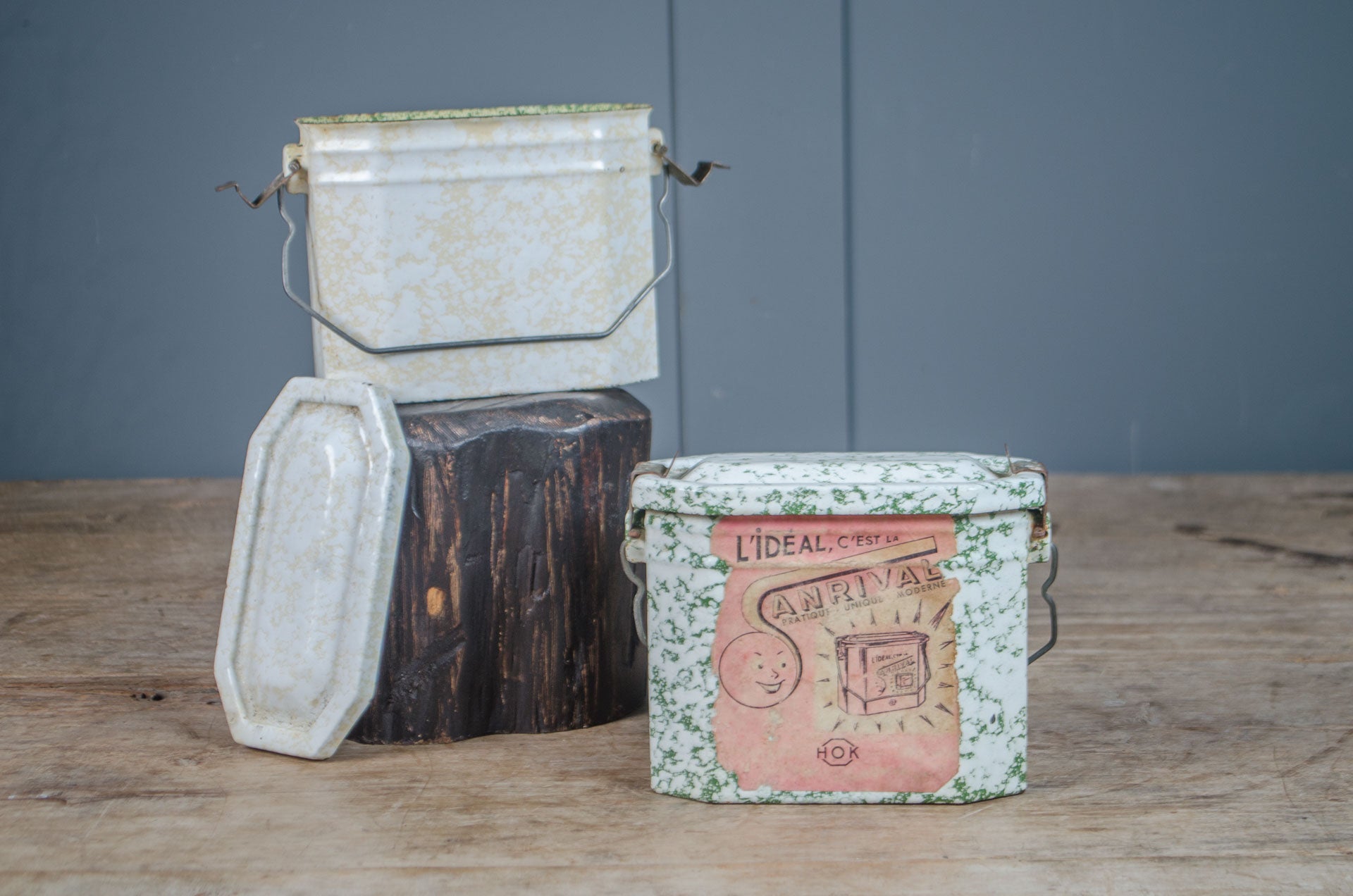 
Vintage French enamel splatter lunch tin with original lid, wire handle and printed French label.