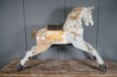 Close-up of antique rocking horse with aged patina and chippy paint detail